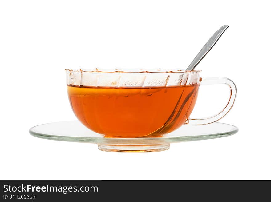 Glass cup with tea and a lemon on a white background