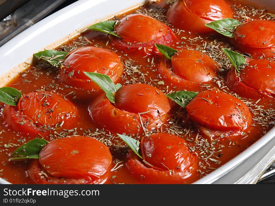 Fresh appetizing cherry tomatoes with water drops on a white background