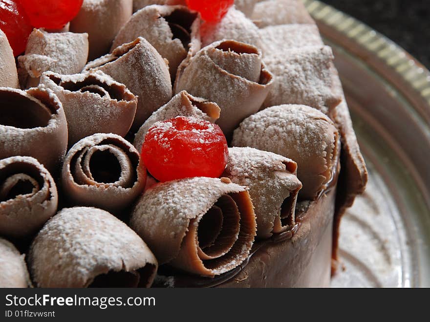 Cake with cherries and chocolate sugar, cherries