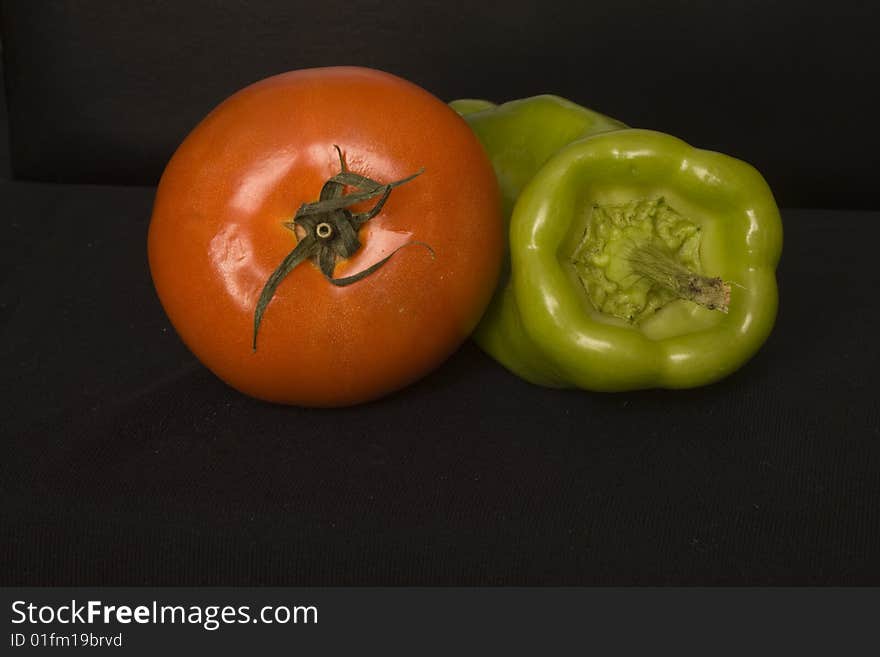 Fresh tomato and green pepper, photographed in the kitchen