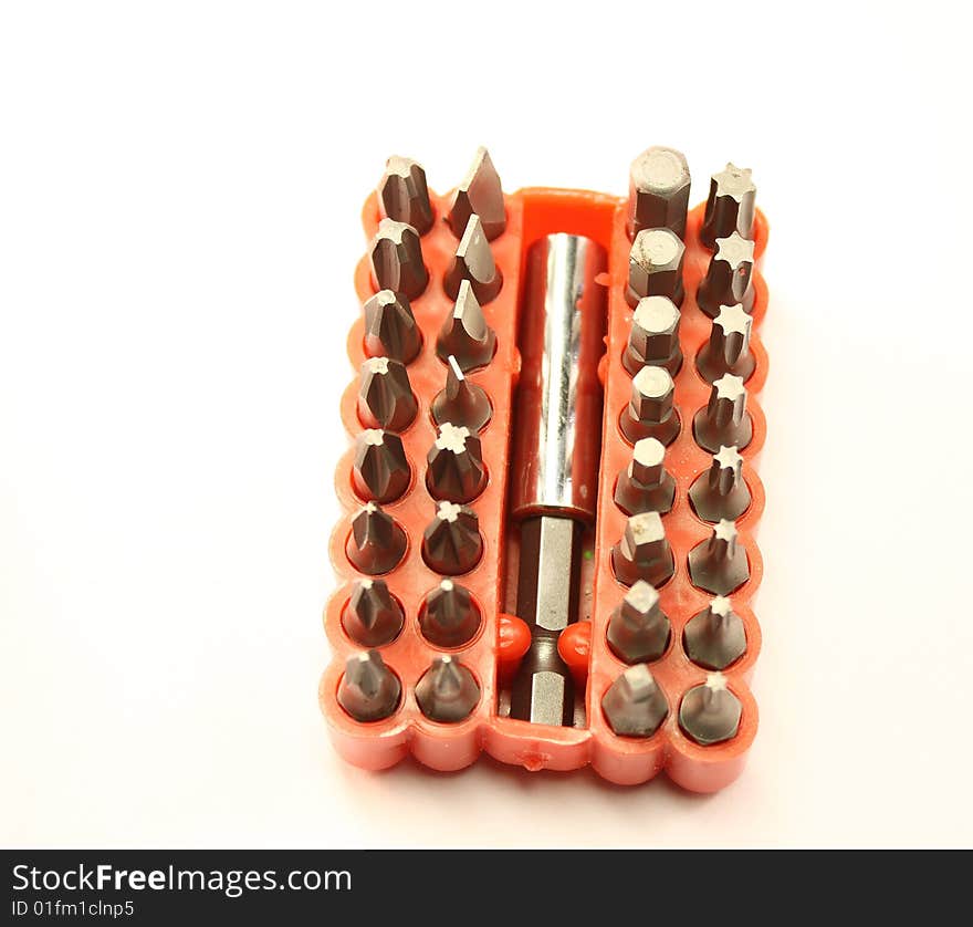 Assortment of screwdriver bits and head on white background. Assortment of screwdriver bits and head on white background.