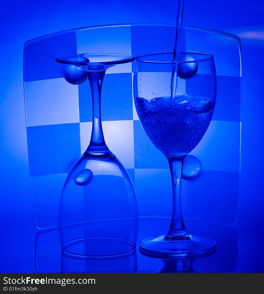 Blue Glass with Splashing water. Coolness Drink. Blue Glass with Splashing water. Coolness Drink