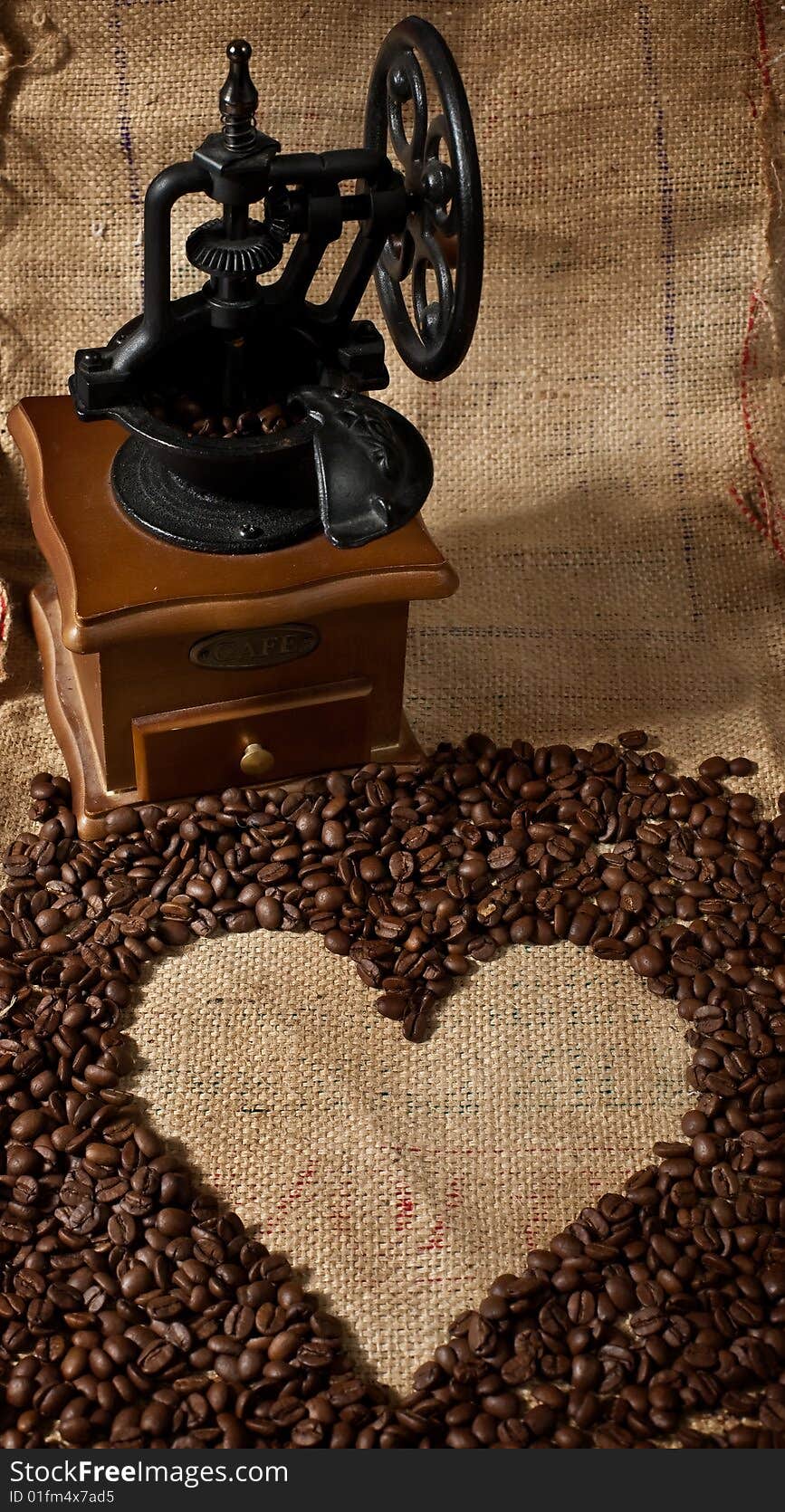 Vintage coffee grinder and heart shape made from coffee beans