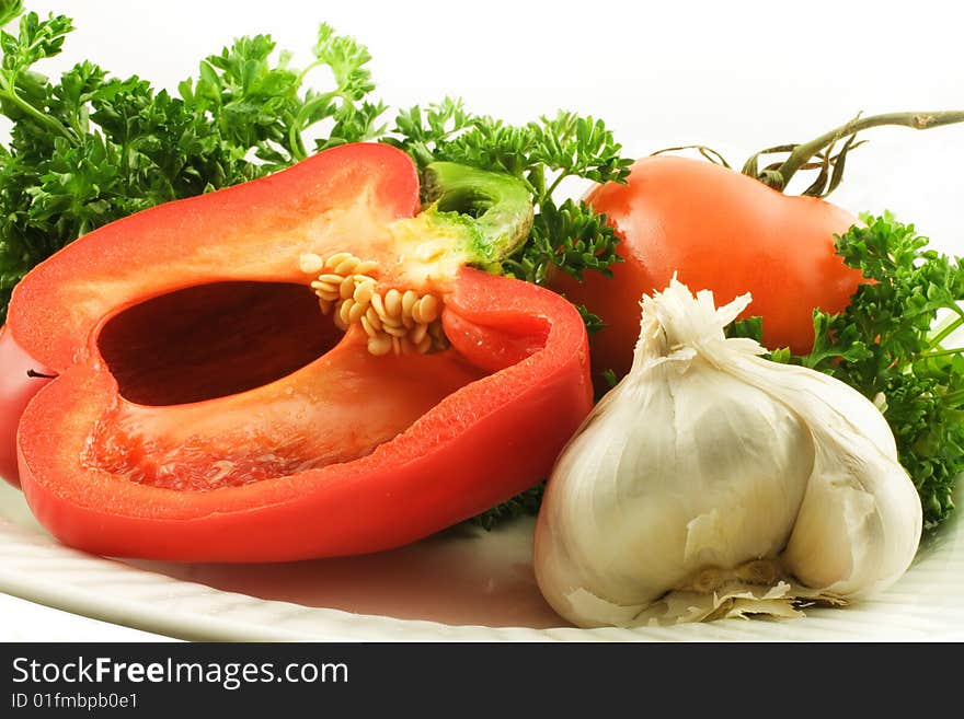 Bell pepper, garlic and tomato in parsley leaves. Bell pepper, garlic and tomato in parsley leaves