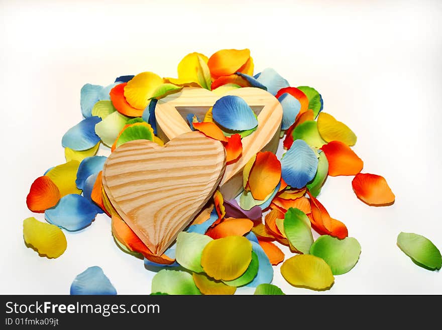 Wood heart box with colored flower petals. Wood heart box with colored flower petals