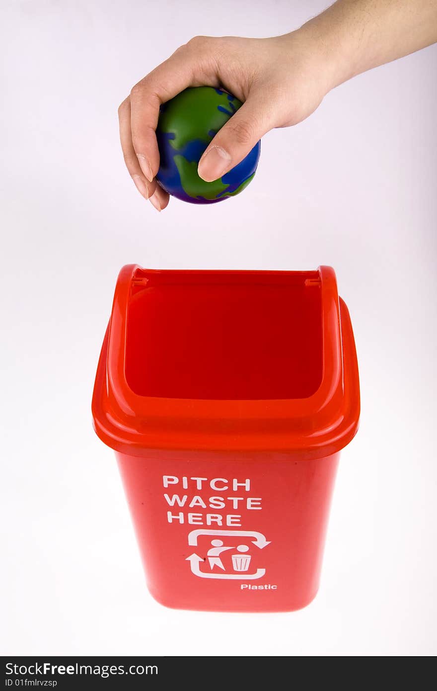 Hand take hold of his globe chuck recycling bin. Hand take hold of his globe chuck recycling bin