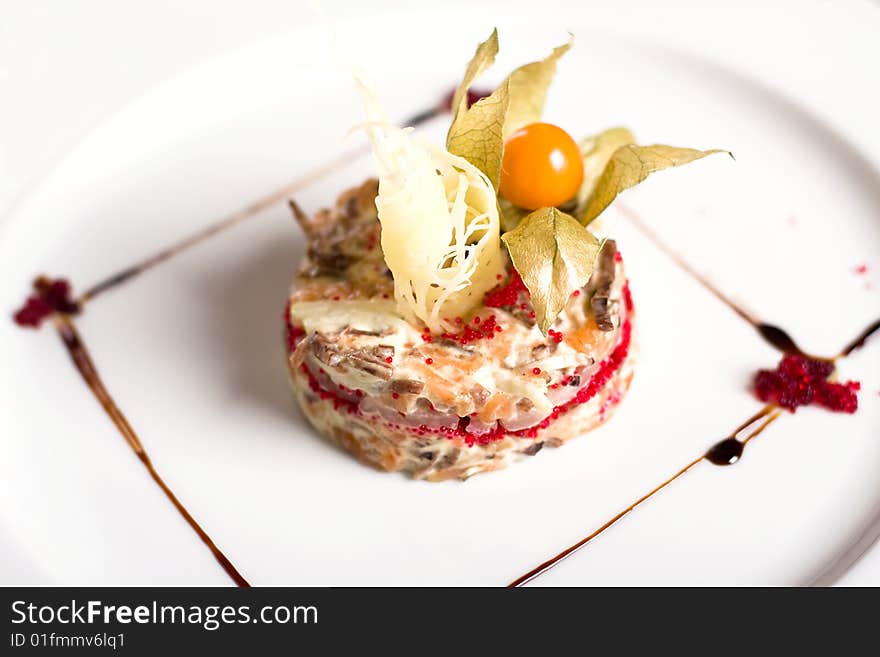 A fusion vegetables and meat salad on a plate (close-up). A fusion vegetables and meat salad on a plate (close-up)