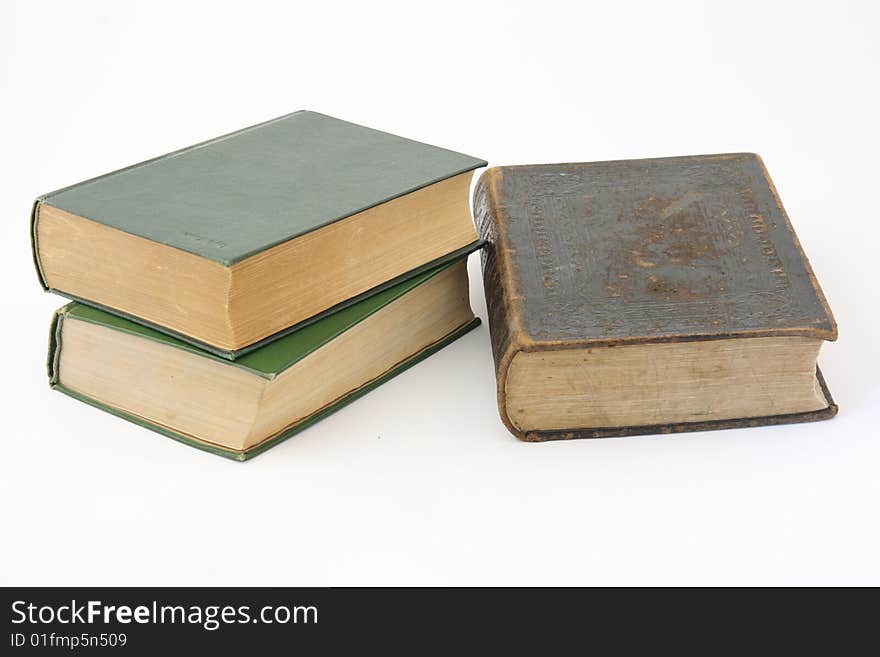 Three old books on a white background