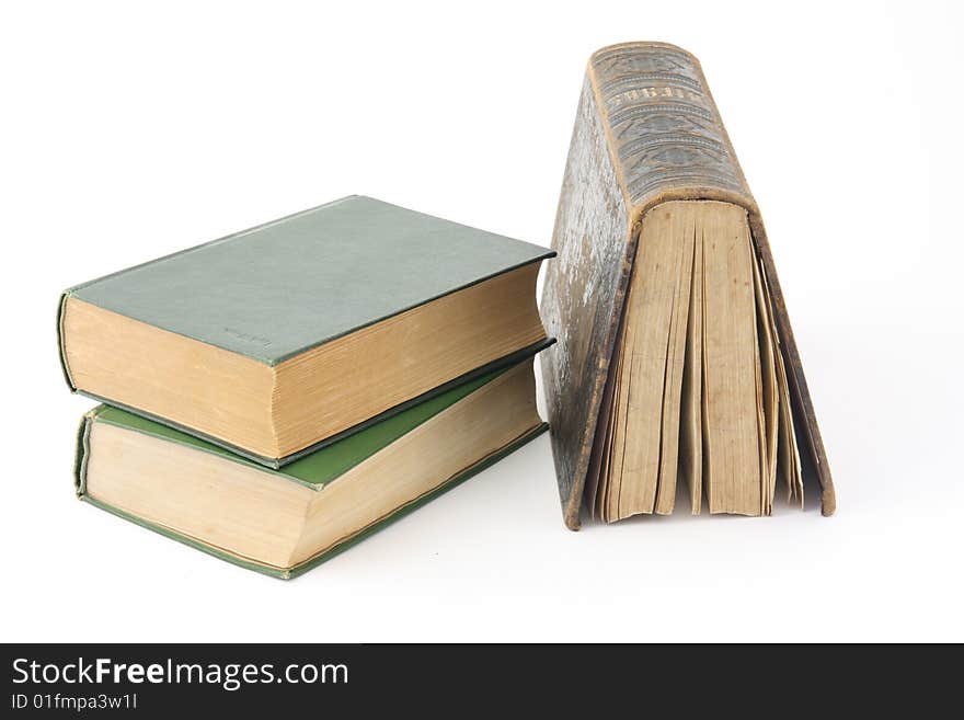 Three old books on a white background