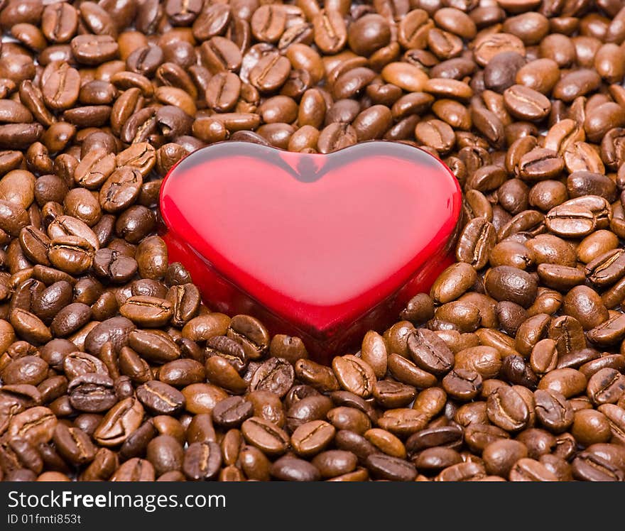 Glossy heart in coffee beans