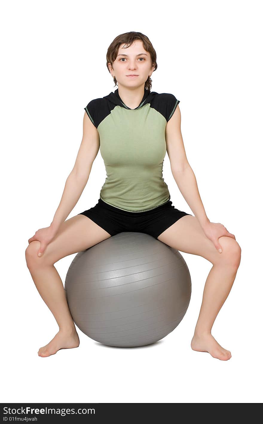 Young slim woman making fitness on a fit-ball isolated at the white background. Young slim woman making fitness on a fit-ball isolated at the white background