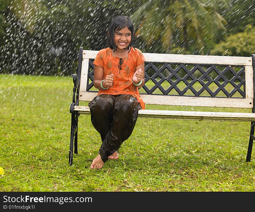 Kid sitting in a park bench