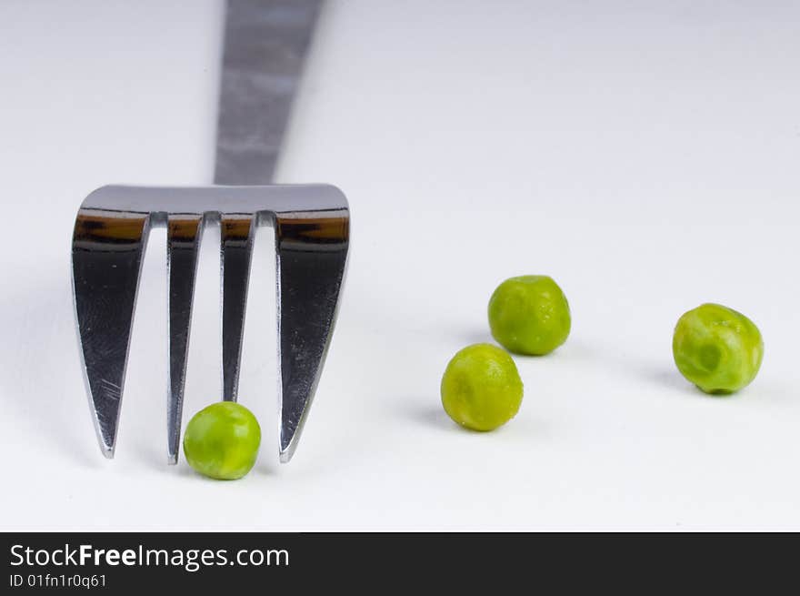 Green peas with fork background. Green peas with fork background