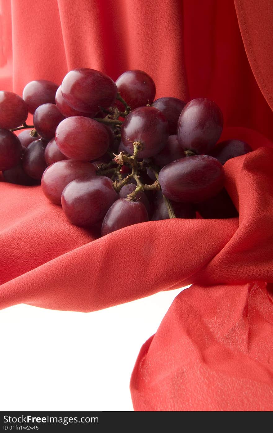 Grapes on red scarf background