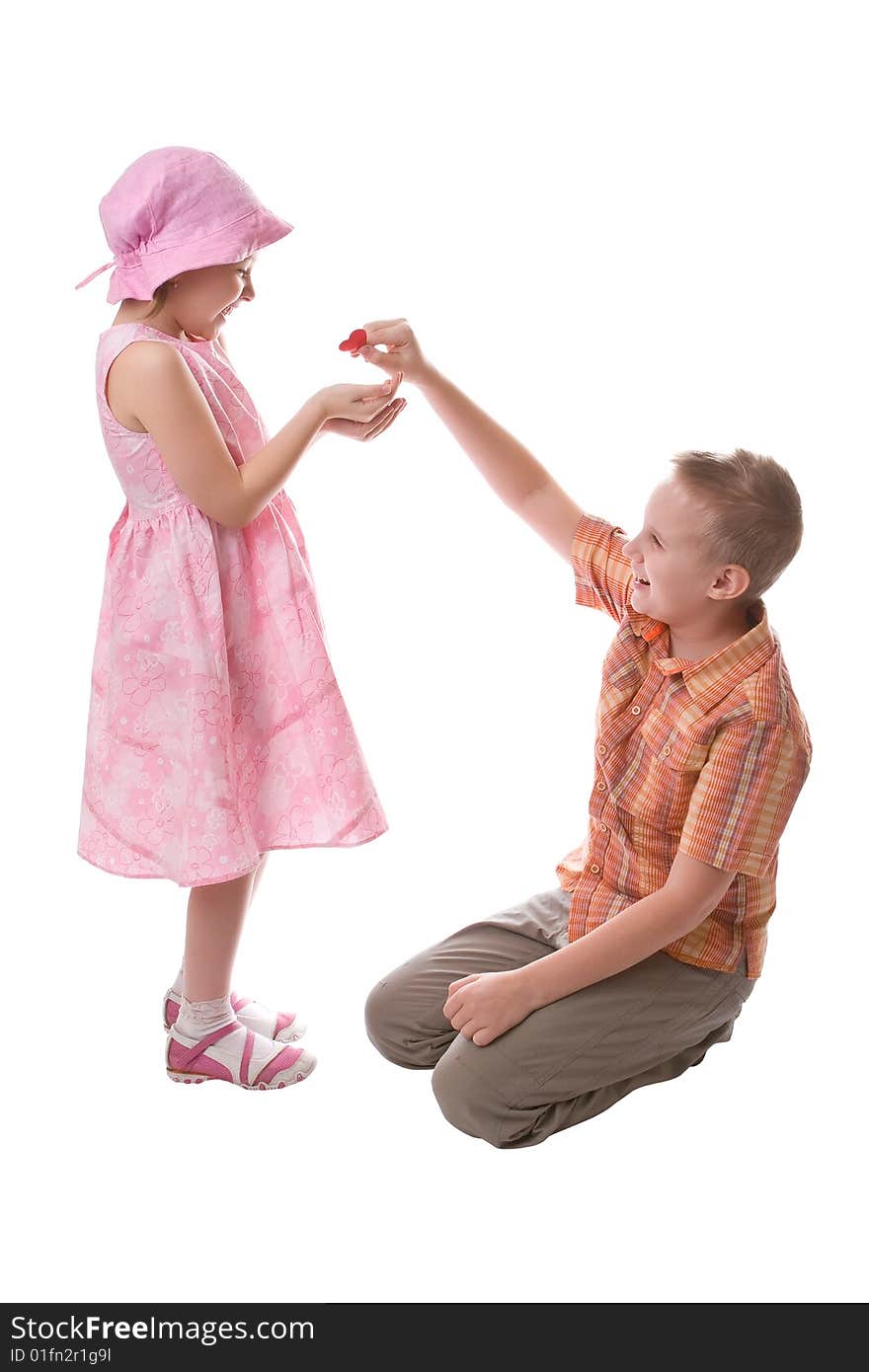 Boy gives to the girl a red heart. Boy gives to the girl a red heart