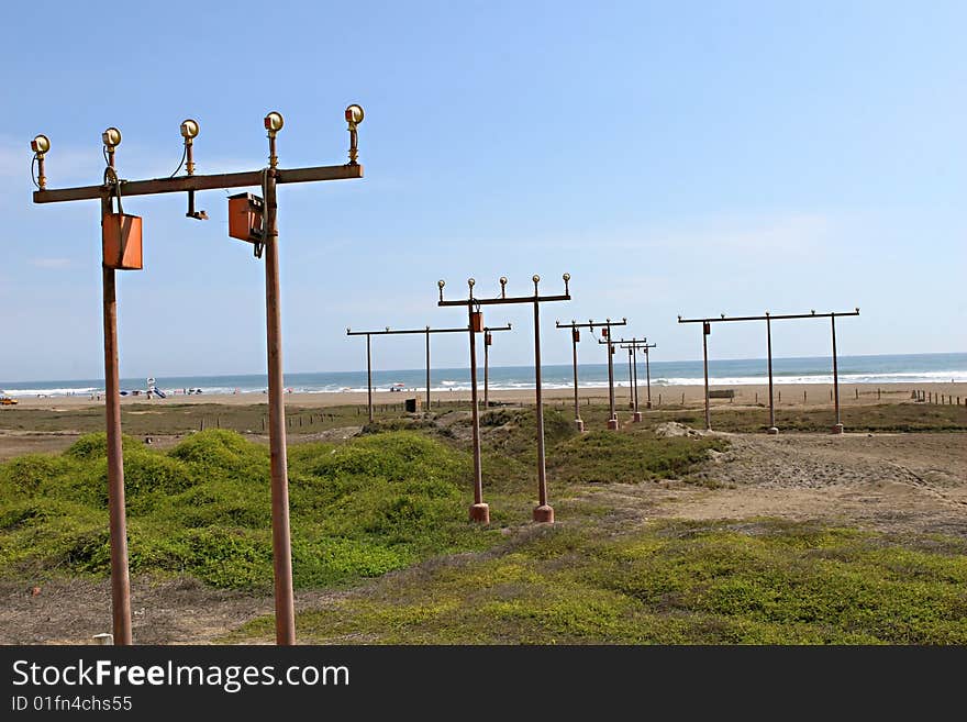 Runway lights on the beach help guide airplanes to the nearby airport. Runway lights on the beach help guide airplanes to the nearby airport