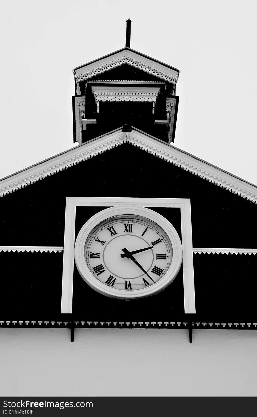 Old white and black chapel with tenon and clock. Old white and black chapel with tenon and clock