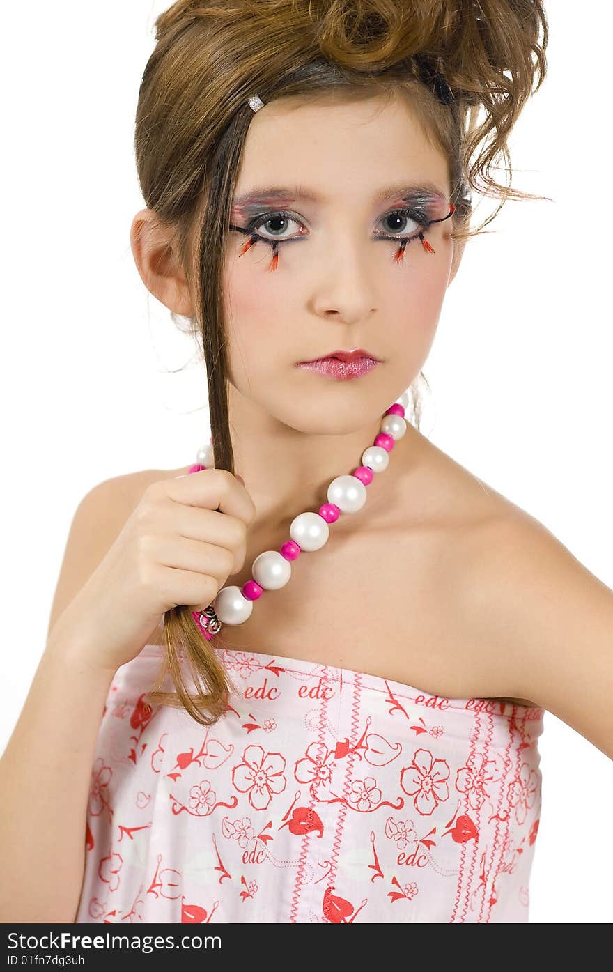 Closeup of young fashion girl with special eye makeup showing jewelry and pink white clothes. Closeup of young fashion girl with special eye makeup showing jewelry and pink white clothes