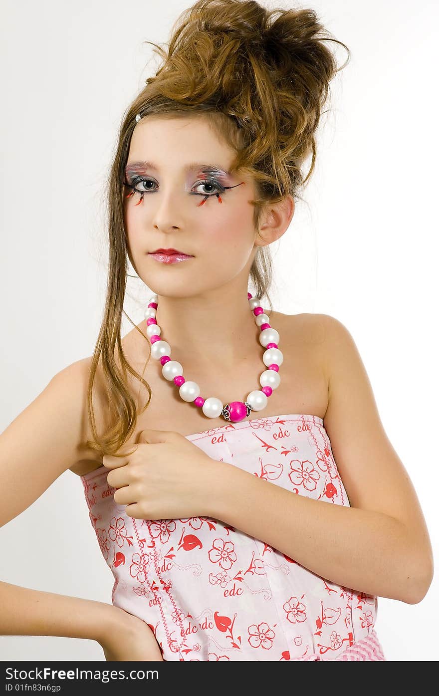 Young fashion girl with special eye makeup showing jewelry and pink white clothes. Young fashion girl with special eye makeup showing jewelry and pink white clothes