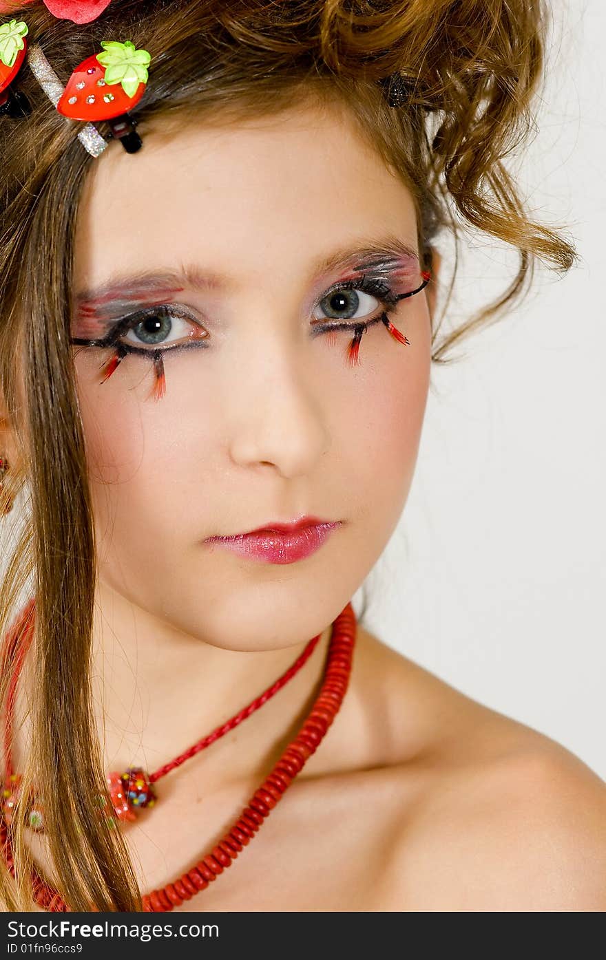 Closeup of young fashion girl with special eye makeup and red necklace. Closeup of young fashion girl with special eye makeup and red necklace