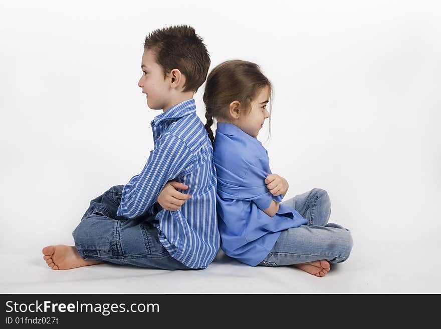 7 yearold boy and his 5 yearold sister sitting back to back. 7 yearold boy and his 5 yearold sister sitting back to back