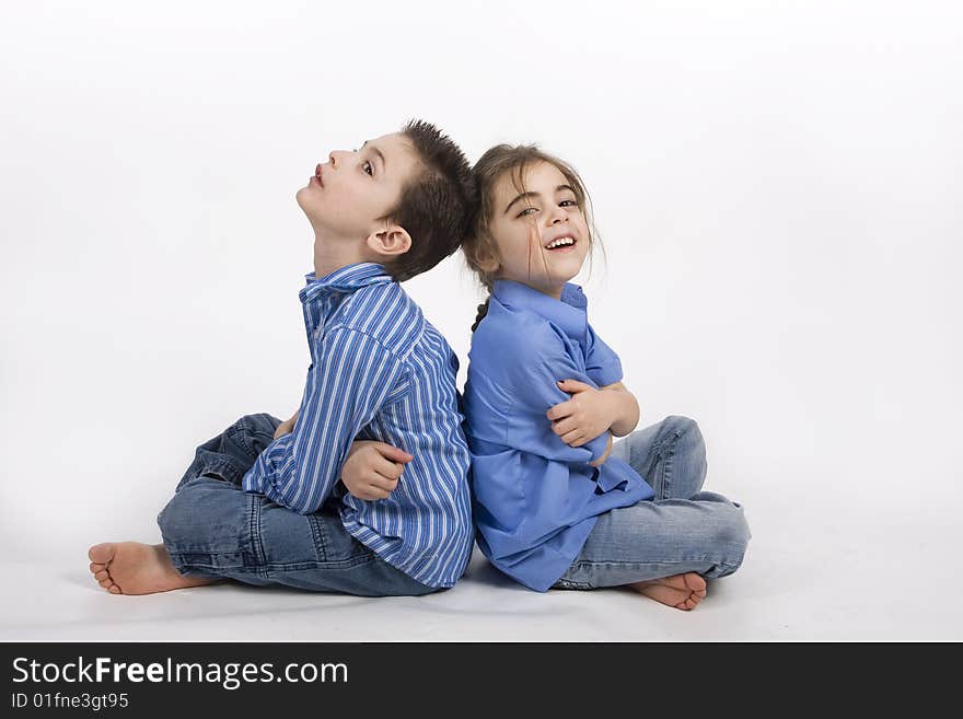 7 yearold boy and his 5 yearold sister sitting back to back. 7 yearold boy and his 5 yearold sister sitting back to back