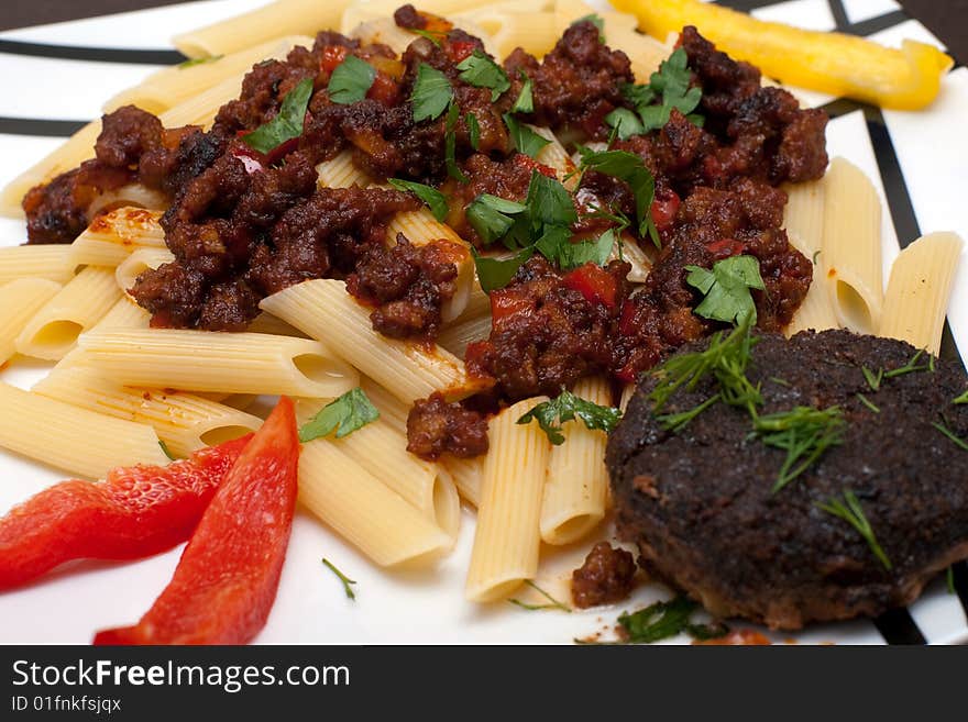 A large platter with cutlet and pasta