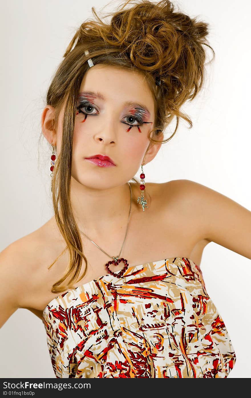 Closeup of young fashion girl with special eye makeup wearing colored top