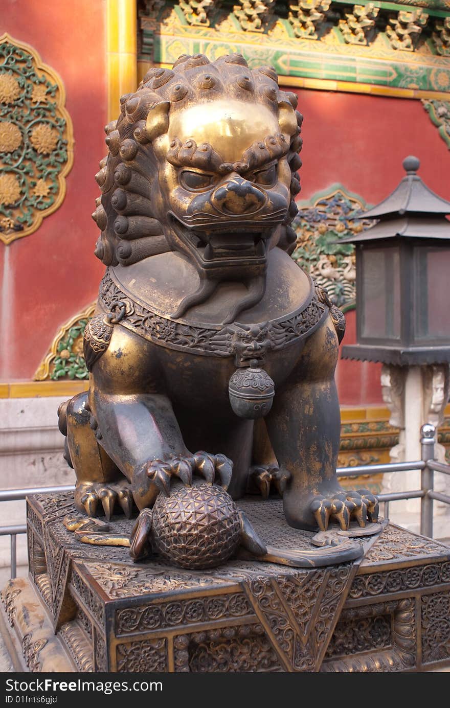 Religious metal lion sitting in the forbidden city