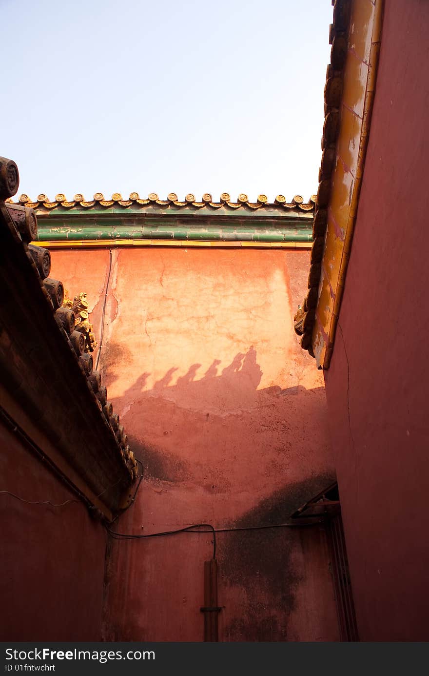 Religious shadow on red wall in the forbidden city. Religious shadow on red wall in the forbidden city