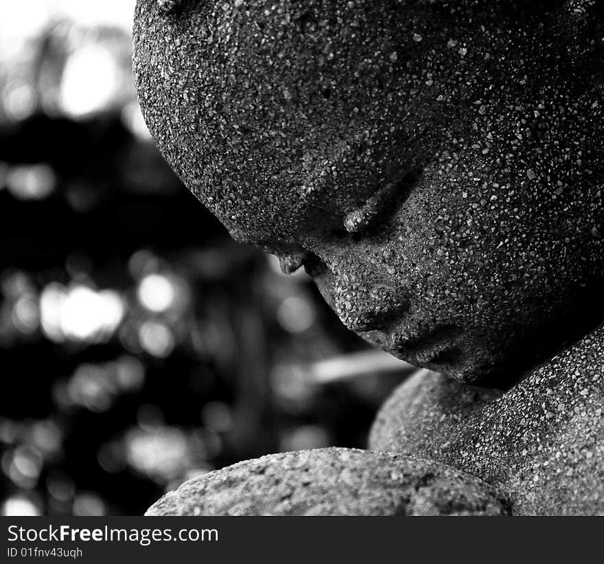 Statue of a baby girl mad out of stone. Statue of a baby girl mad out of stone