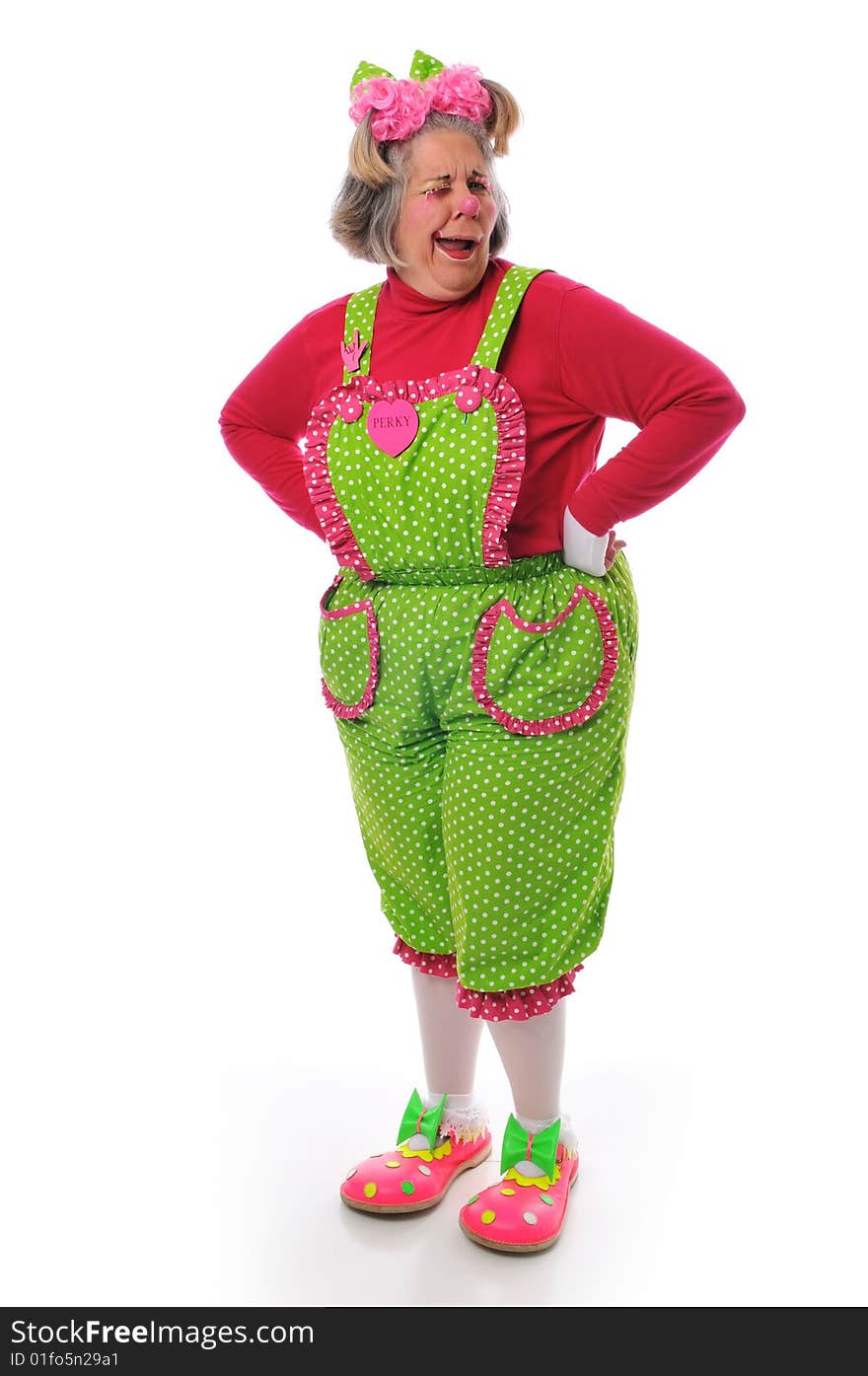 Happy clown making faces and posing against a white background