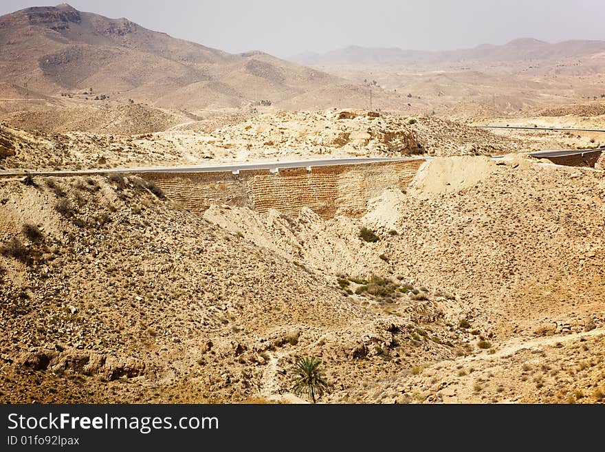 Hot summer sahara desert with one road only