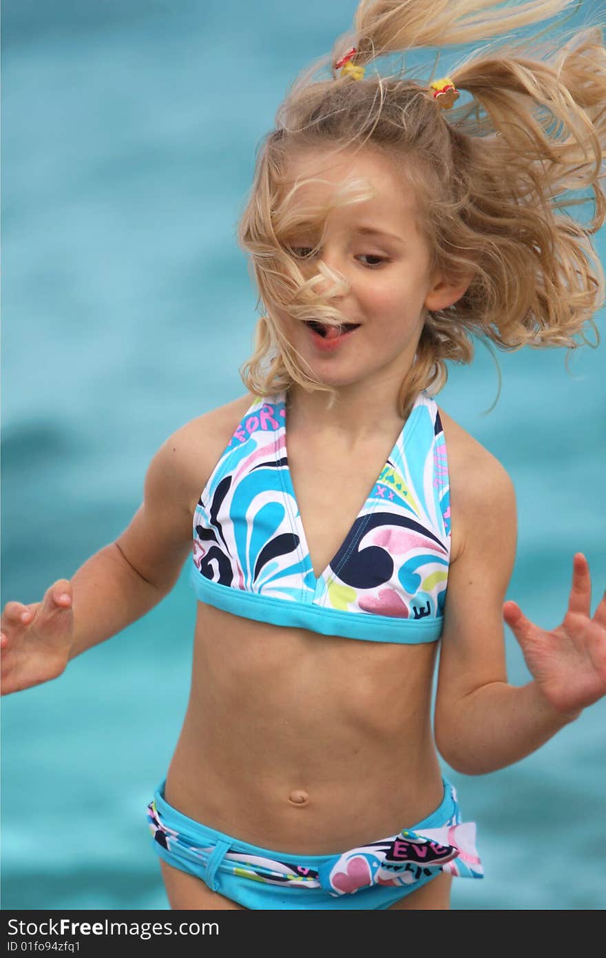 Little girl jumping on the beach