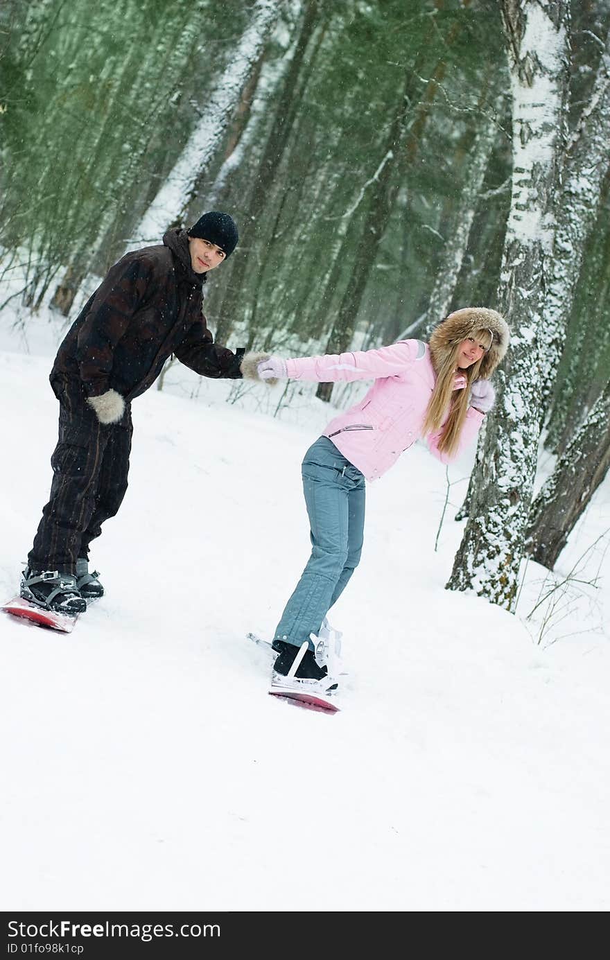 Young couple smowboarding on the mountain