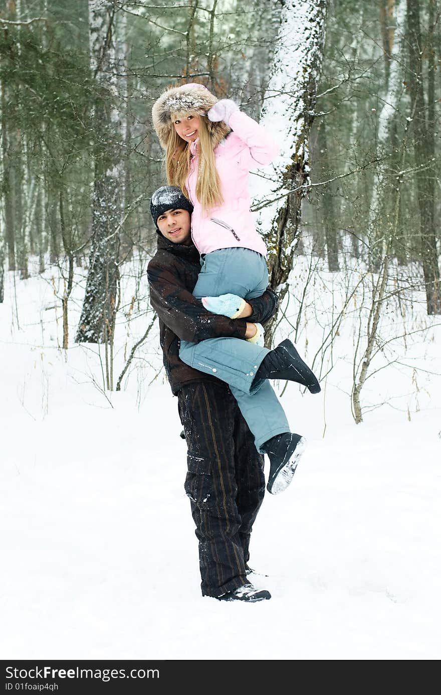 Portrait of a beautiful young couple having fun in winter park. Portrait of a beautiful young couple having fun in winter park