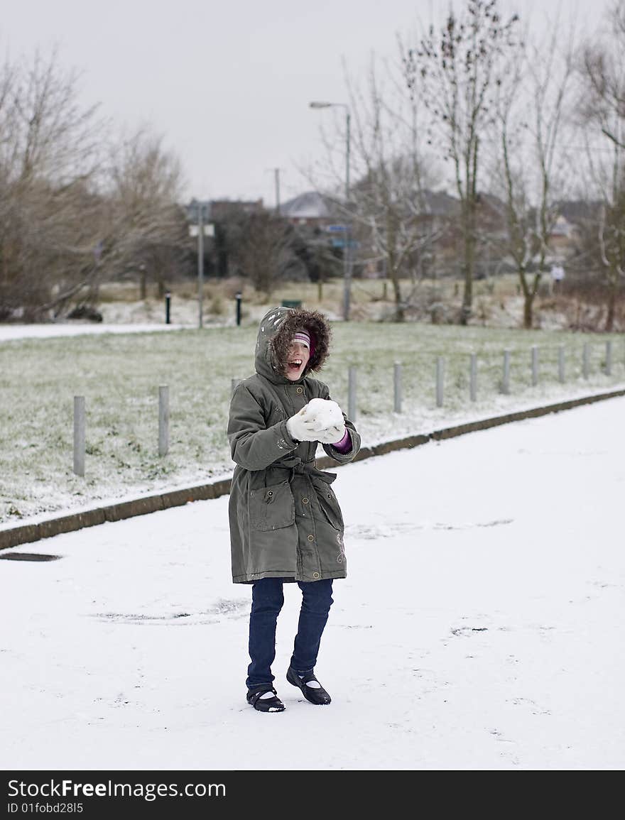 Girl playing in the snow and laughing hard. Girl playing in the snow and laughing hard