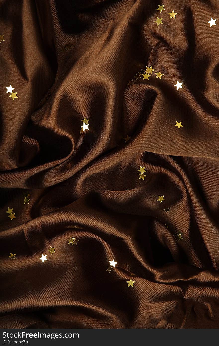 Brown textile background with little golden stars. Brown textile background with little golden stars