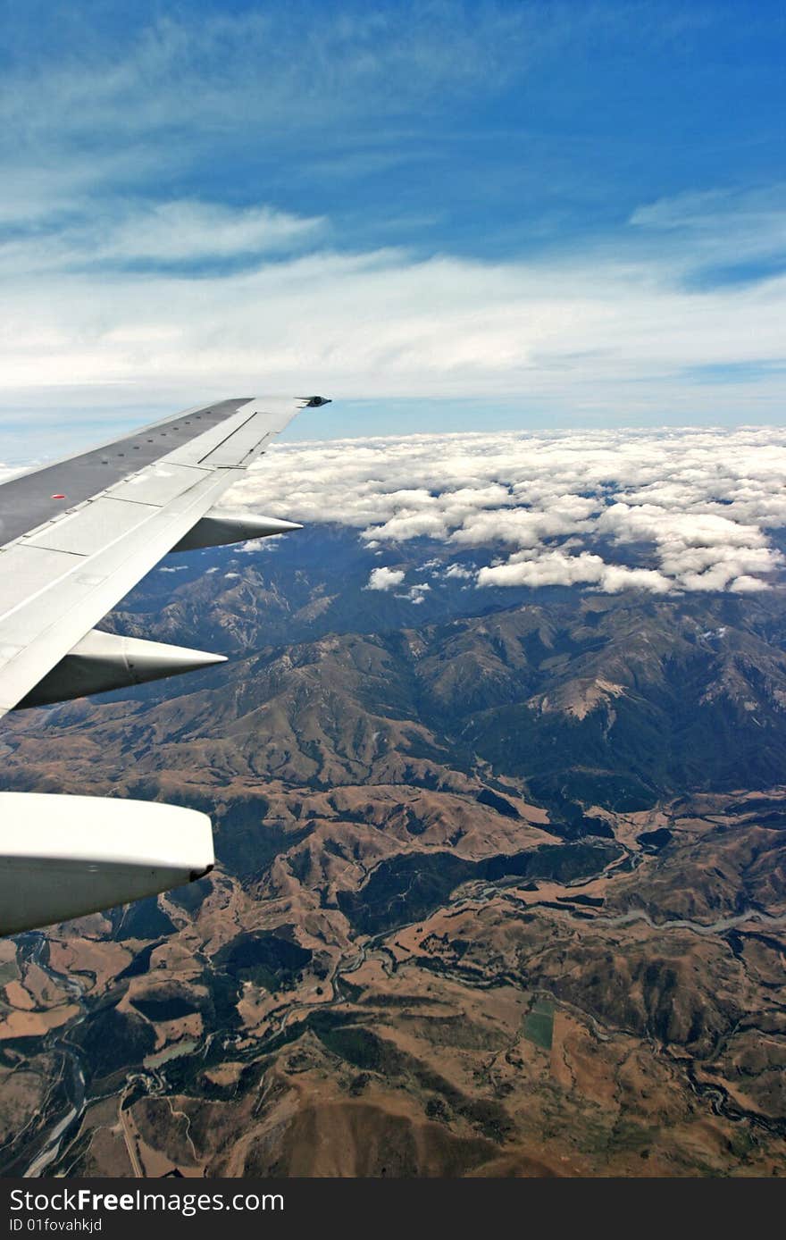 Airplane over cloudy sky vertical