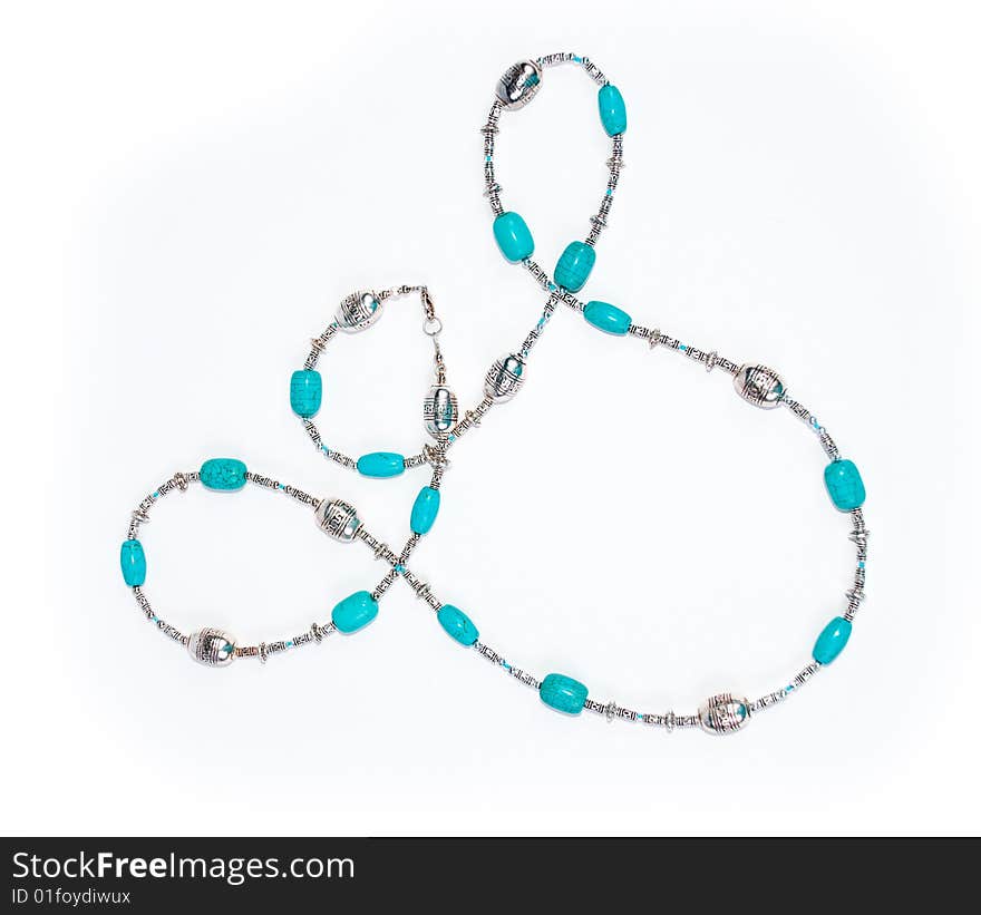 Blue beads on white background with turquoise