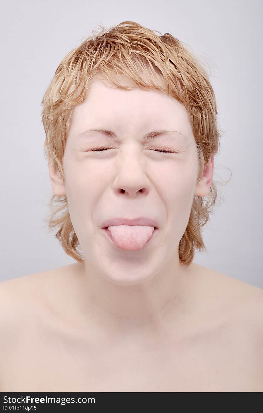 Portrait of the young woman with tongue