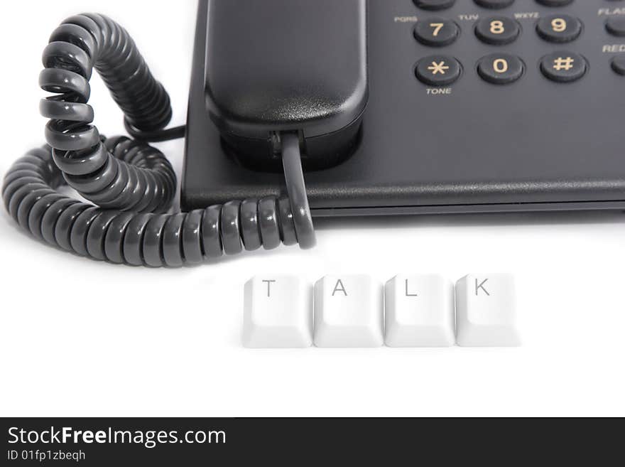 Phone talk: black office telephone and TALK caption