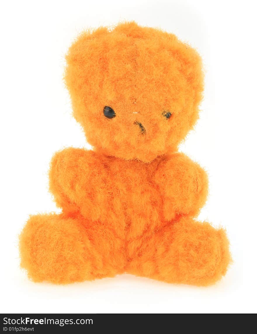 A very old orange teddy bear on white background