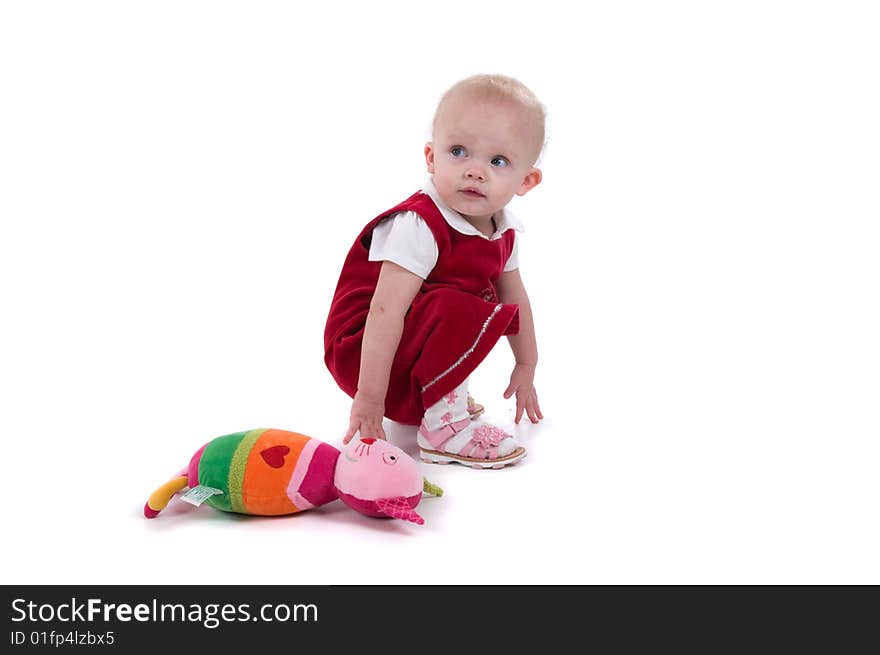 Surprised baby with toy sitting on the floor. Surprised baby with toy sitting on the floor