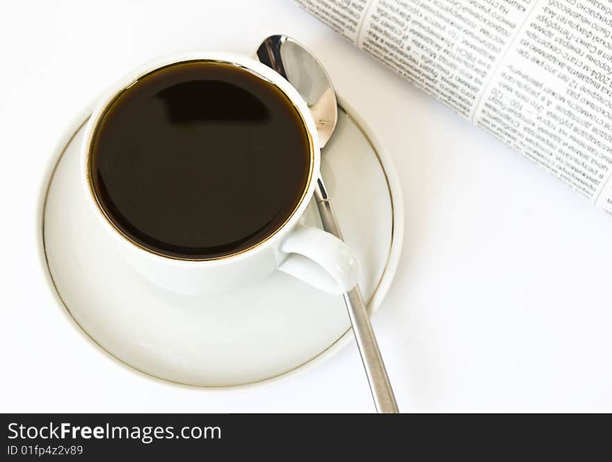 Cup of coffee and newspaper on white background