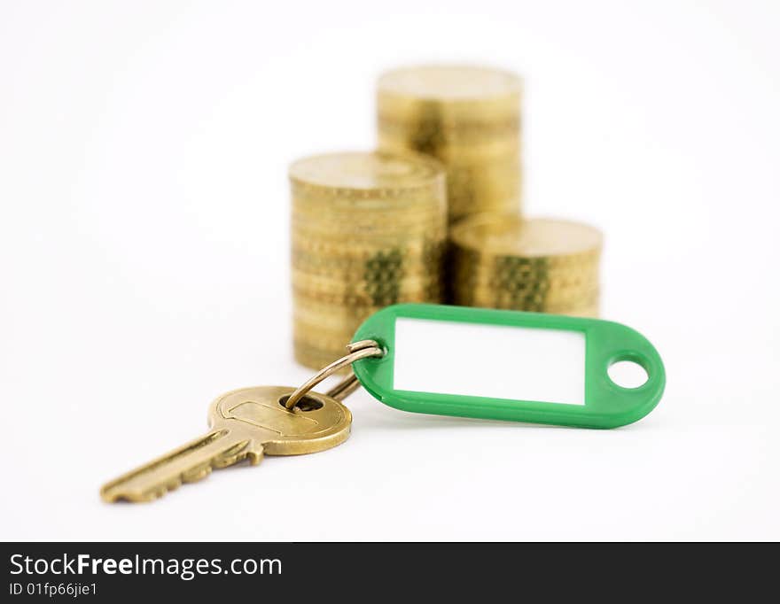 Key with coins isolated on white