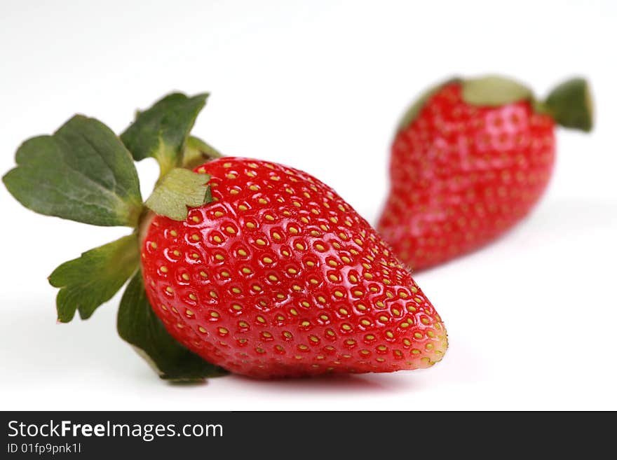 Two Delicious red strawberries isolated