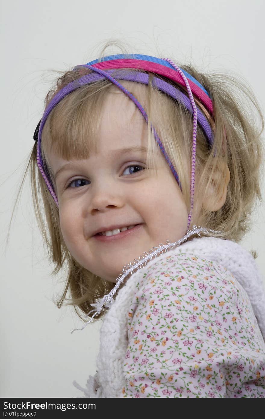 Girl with headbands stares directly at camera. Girl with headbands stares directly at camera