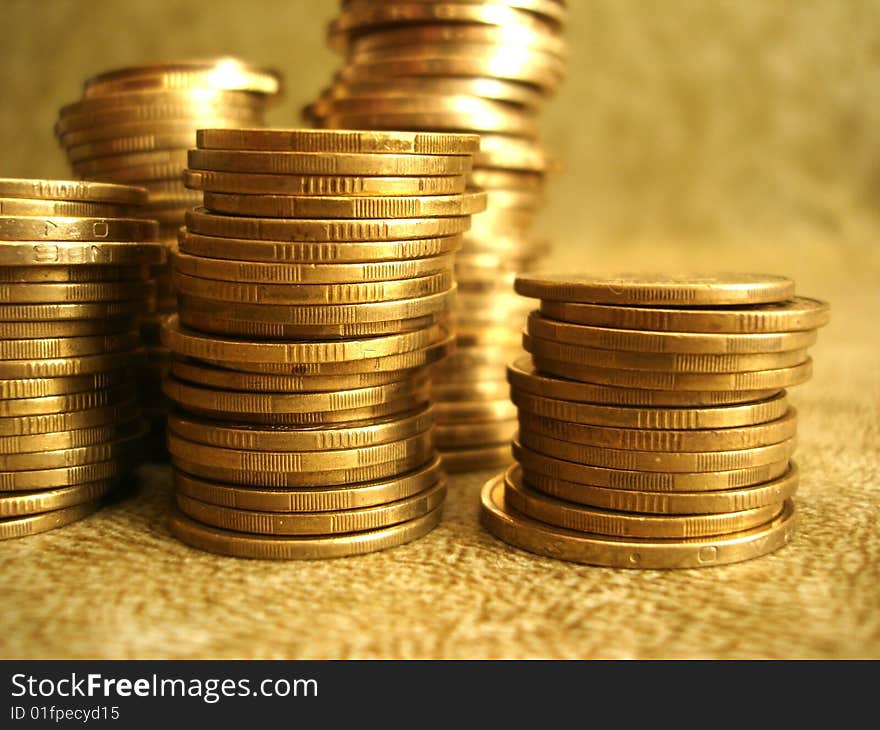 Stack of golden coins on yellow background