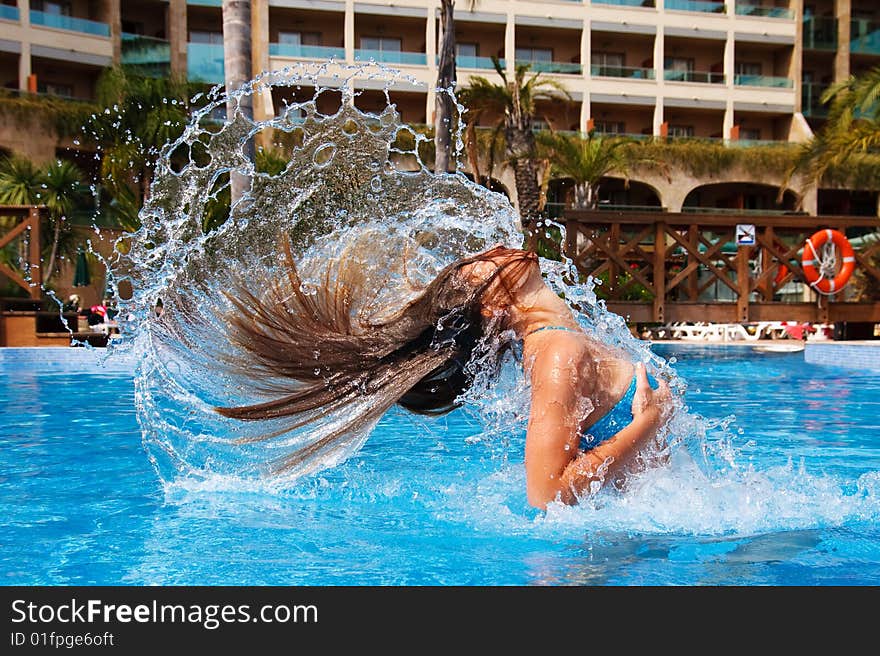 Young woman playing in the swimming pool. Young woman playing in the swimming pool